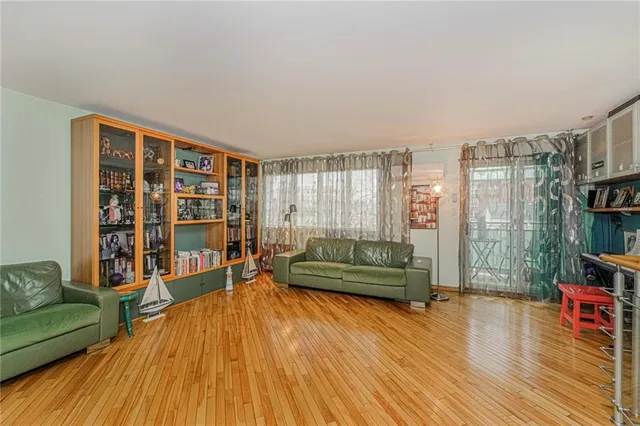a living room with furniture and a book shelf