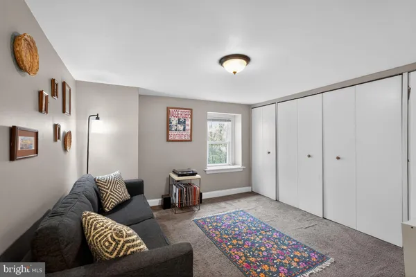 a living room with furniture and a rug
