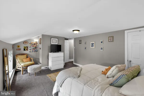 a bedroom with a white bed and white walls