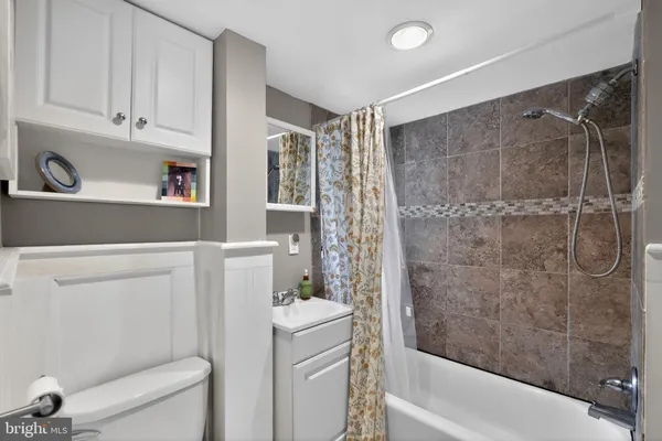 a bathroom with a shower a toilet and a sink