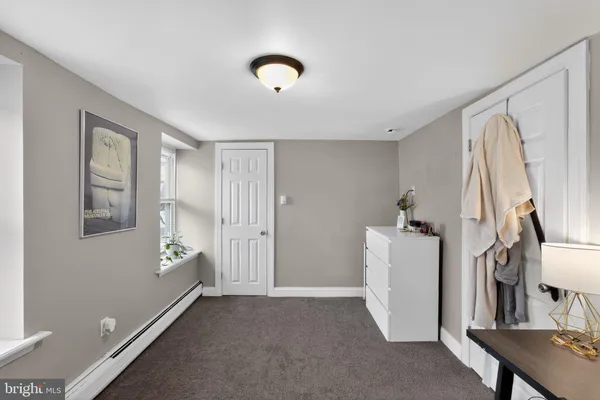 a view of hallway with furniture and a window