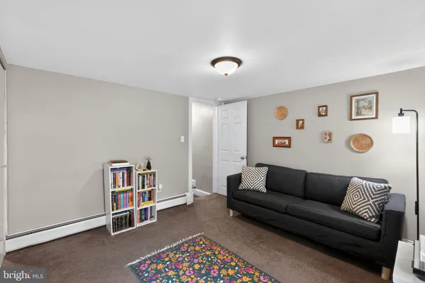 a living room with furniture and a bookshelf
