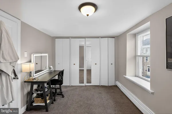 a view of a workspace with furniture and entryway