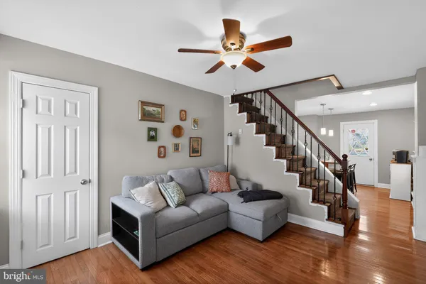 a living room with furniture and wooden floor