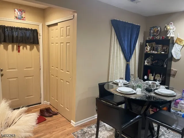 a kitchen with kitchen island granite countertop a sink cabinets and stainless steel appliances