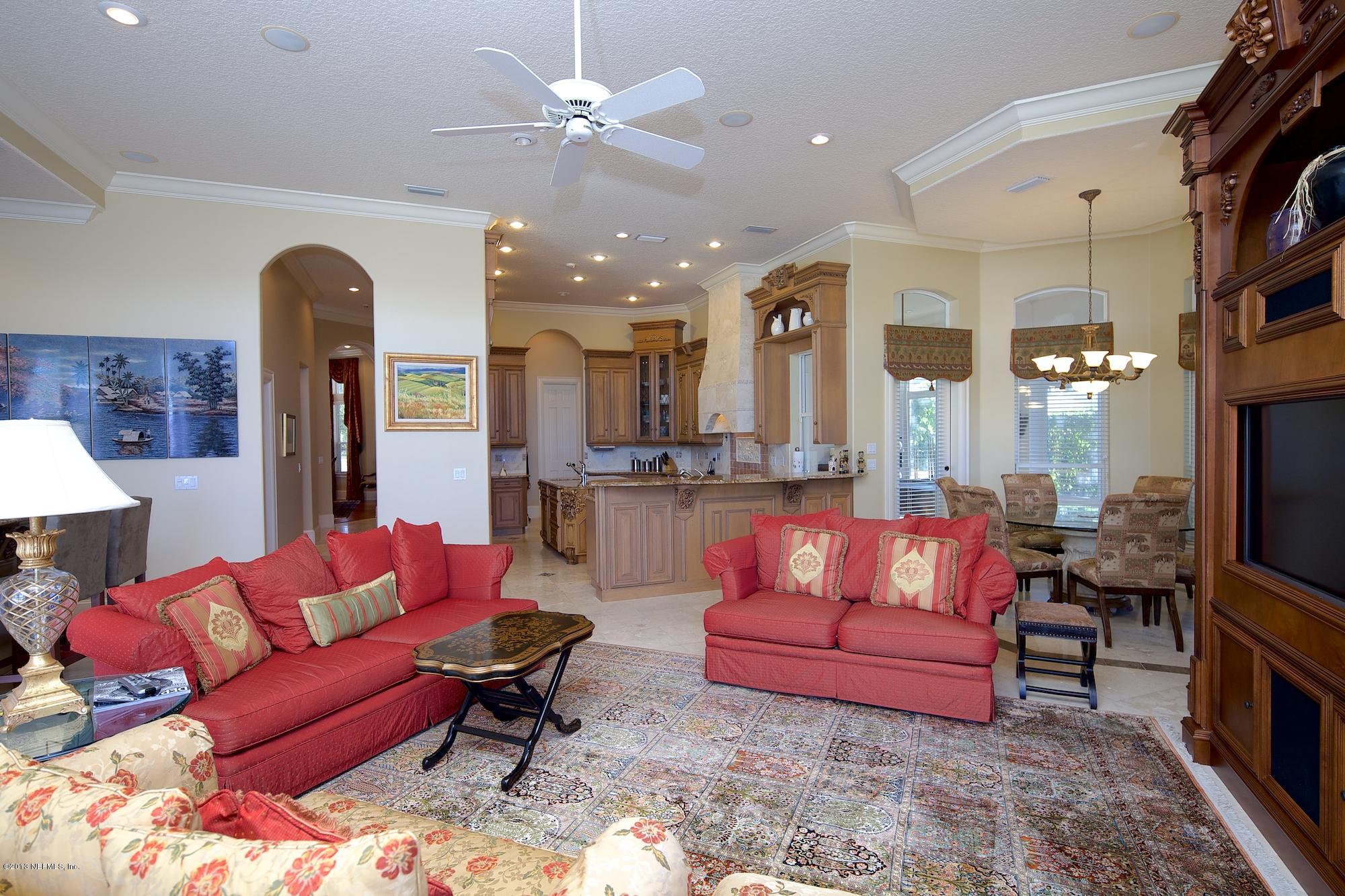 12946 Mandarin Road Jacksonville, FL 32223 - Photo 21 of 67 a living room with furniture a fireplace and a flat screen tv