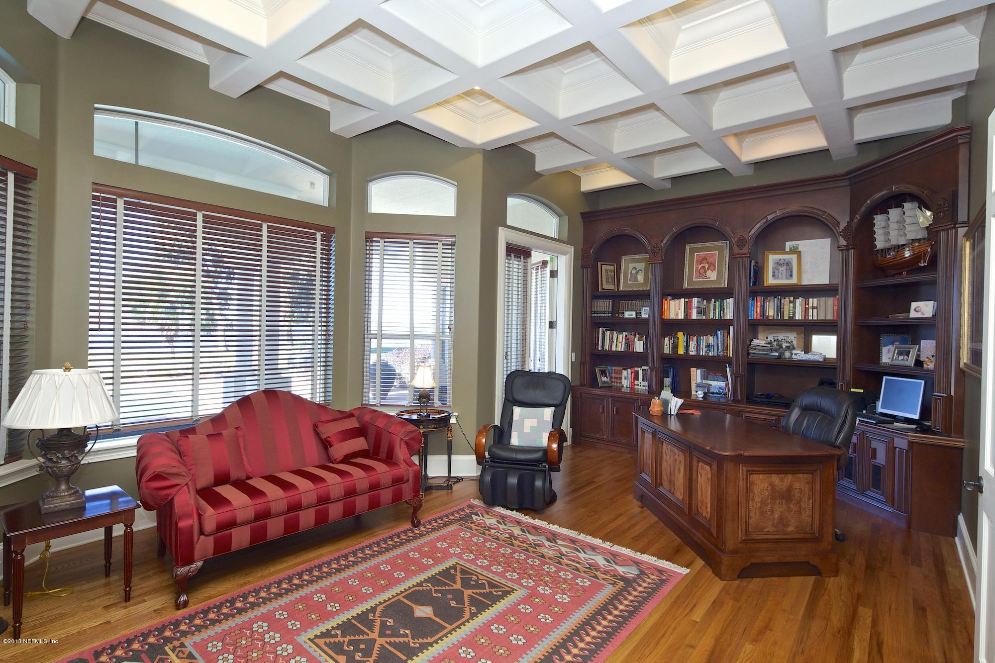 12946 Mandarin Road Jacksonville, FL 32223 - Photo 23 of 67 a living room with furniture and a book shelf