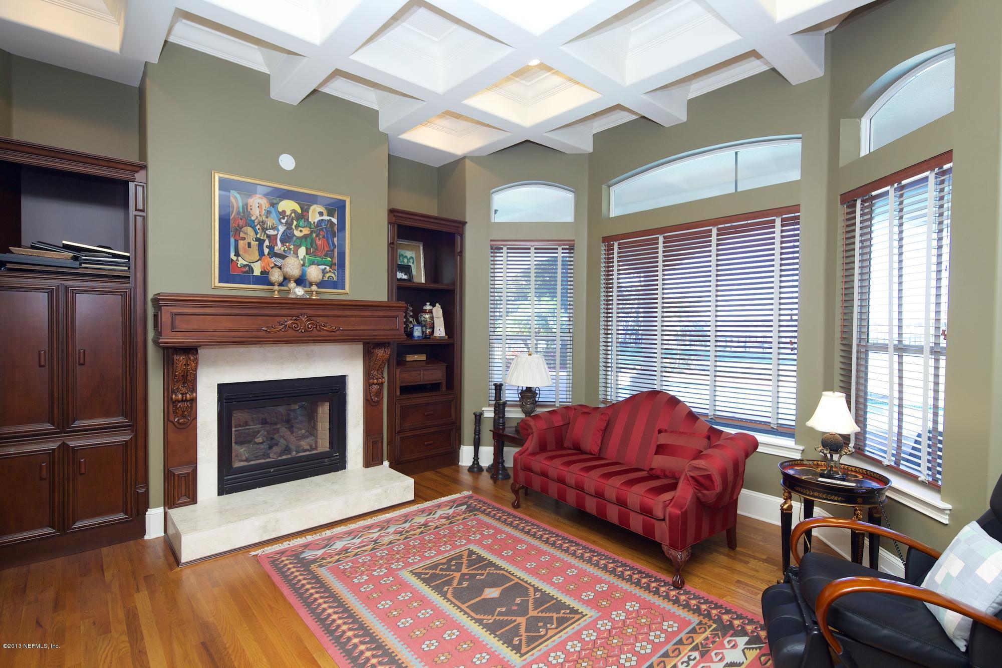 12946 Mandarin Road Jacksonville, FL 32223 - Photo 24 of 67 a living room with furniture windows and a fireplace