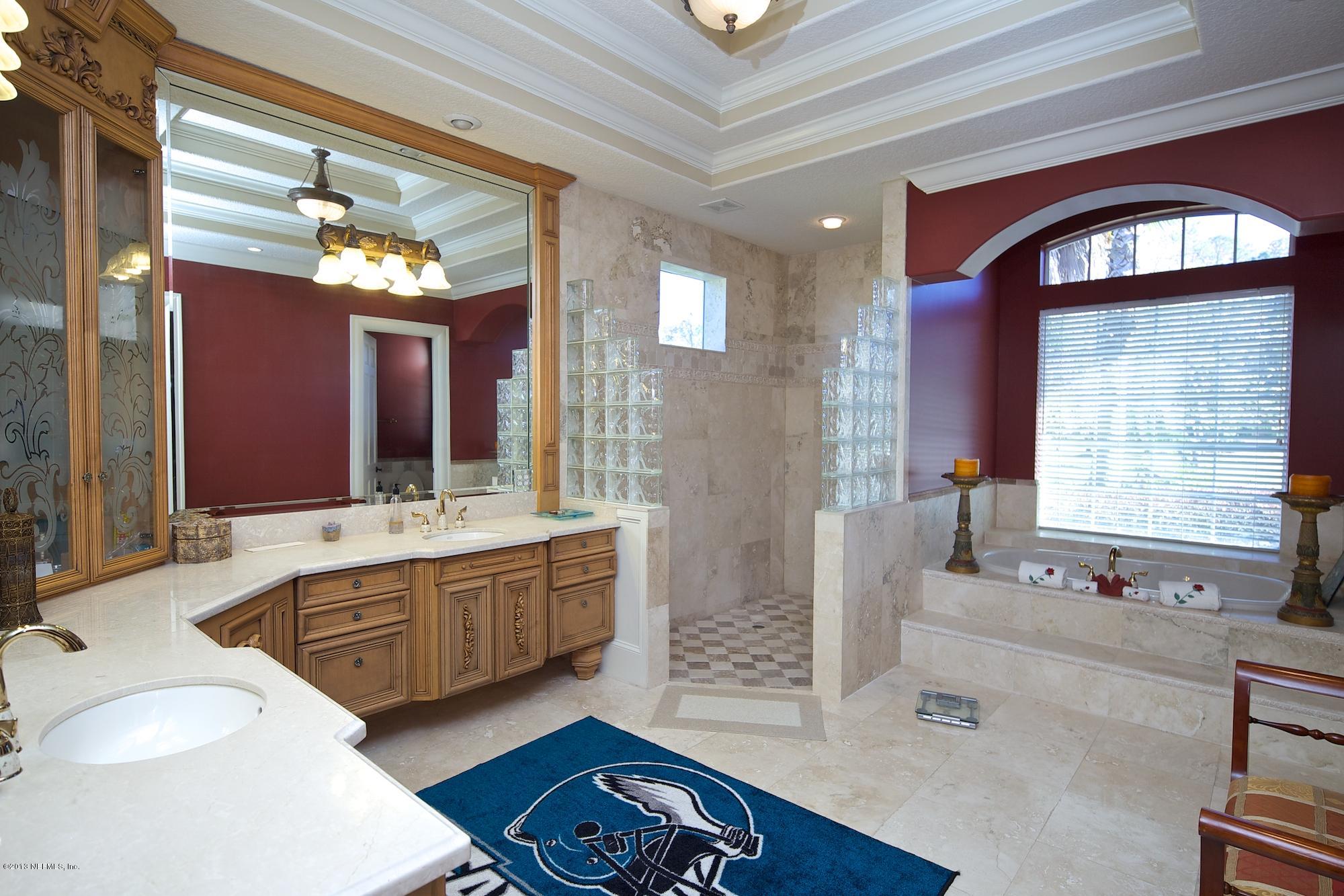 12946 Mandarin Road Jacksonville, FL 32223 - Photo 27 of 67 a spacious bathroom with a granite countertop tub a double vanity sink a mirror and a shower