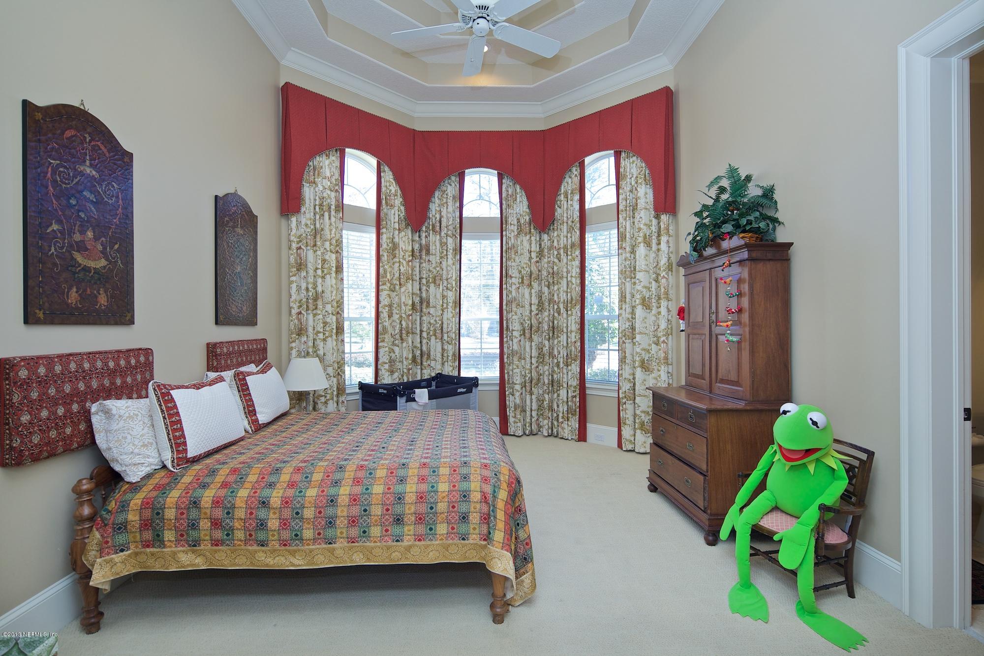 12946 Mandarin Road Jacksonville, FL 32223 - Photo 30 of 67 a bedroom with a bed and a chandelier