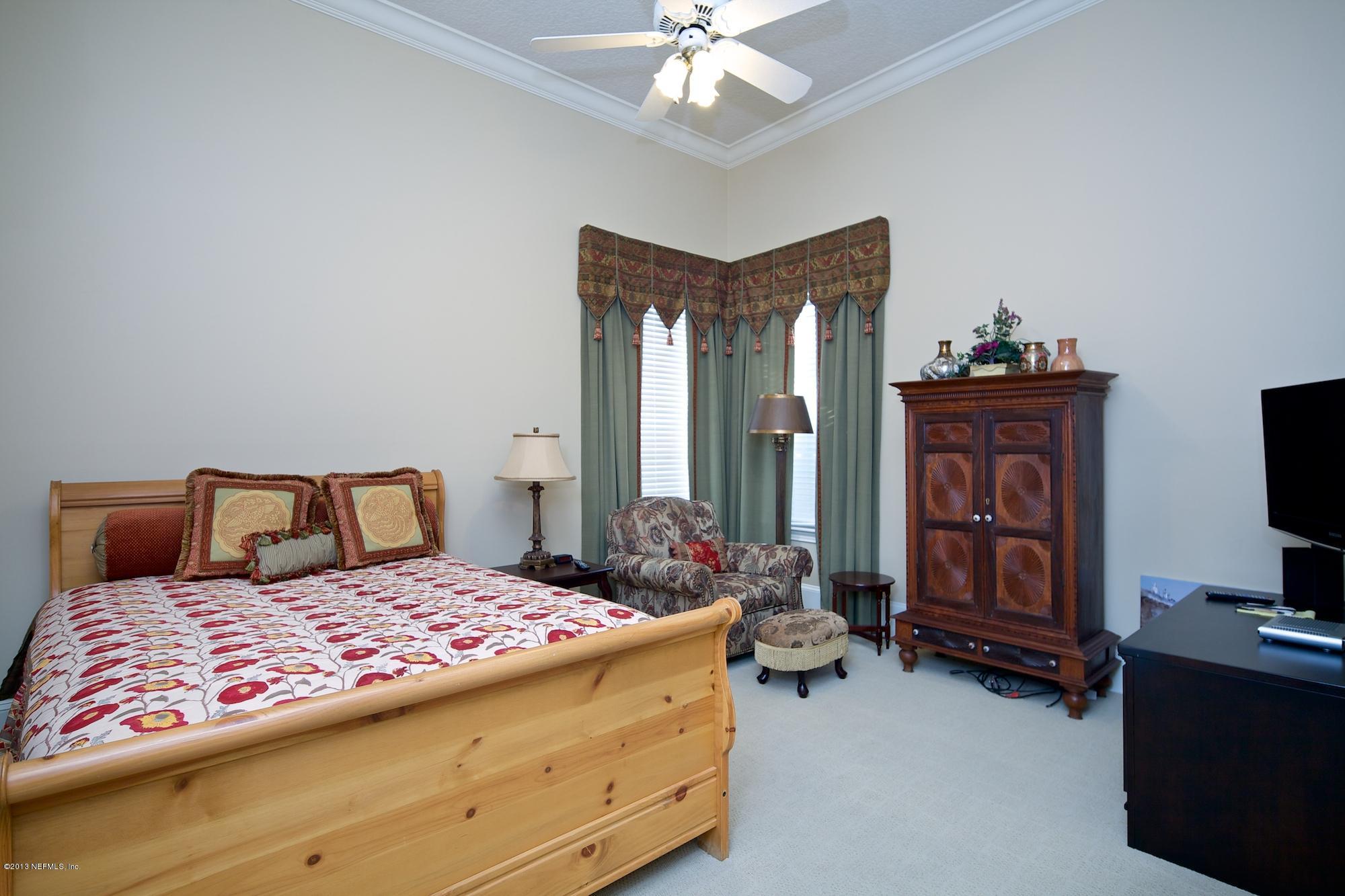 12946 Mandarin Road Jacksonville, FL 32223 - Photo 31 of 67 a bedroom with a bed and a flat tv screen on dresser