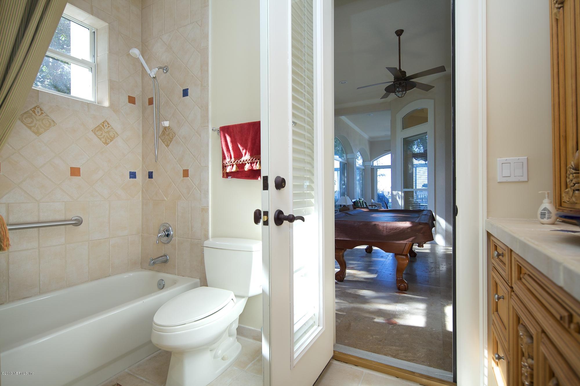 12946 Mandarin Road Jacksonville, FL 32223 - Photo 32 of 67 a bathroom with a toilet a sink and a bathtub next to a window