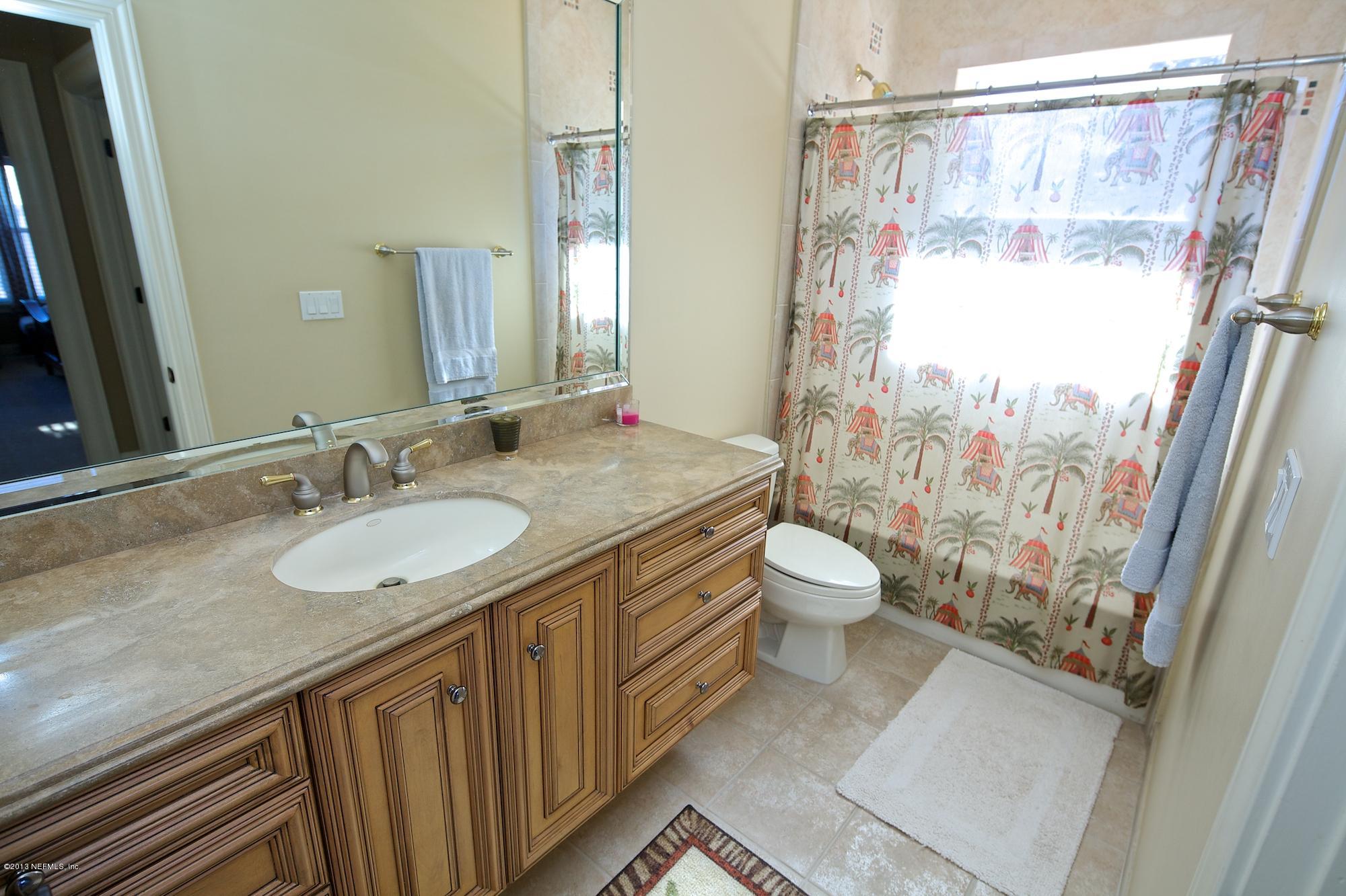 12946 Mandarin Road Jacksonville, FL 32223 - Photo 37 of 67 a bathroom with a granite countertop sink toilet and shower