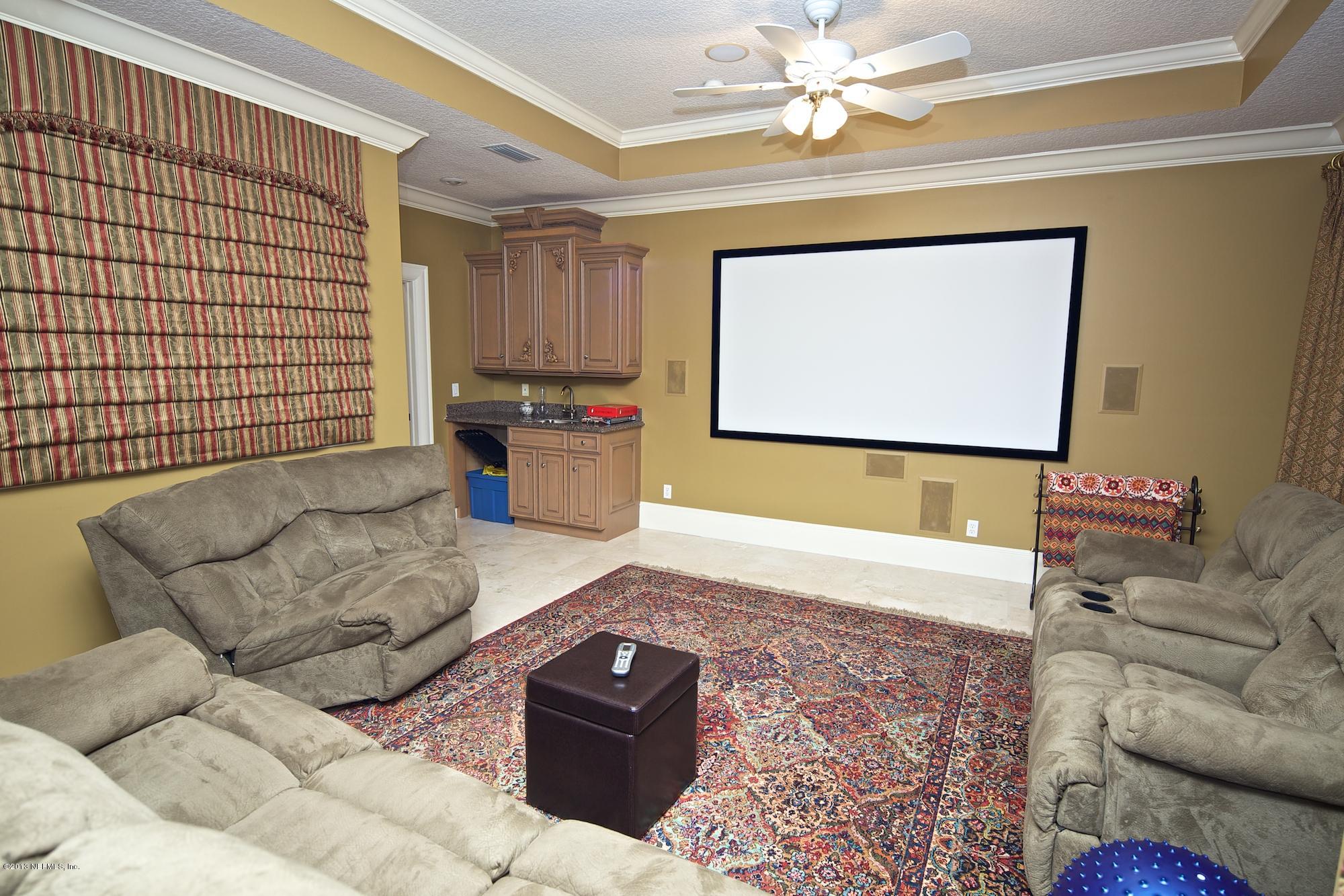12946 Mandarin Road Jacksonville, FL 32223 - Photo 42 of 67 a living room with furniture and a flat screen tv