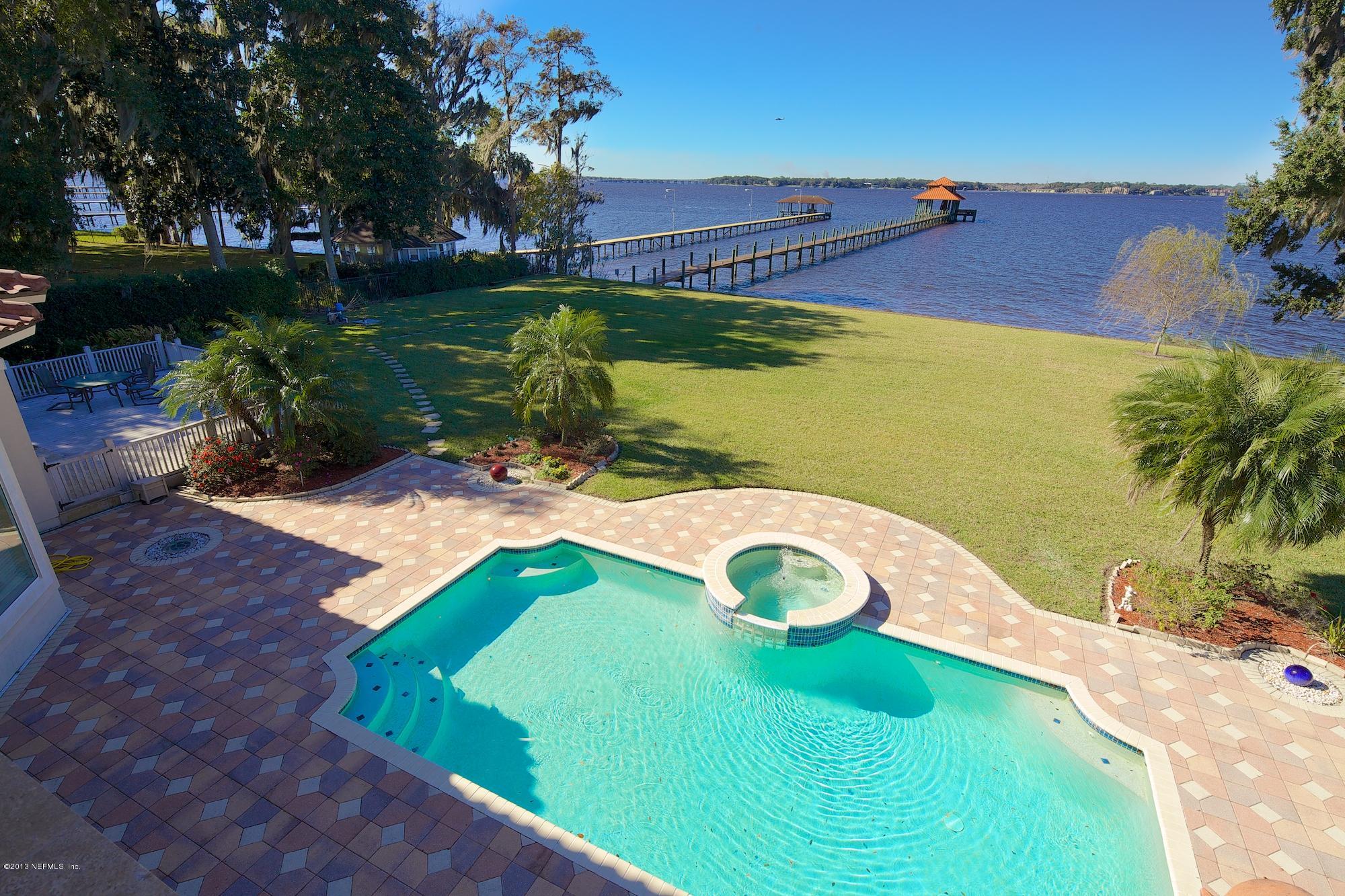 12946 Mandarin Road Jacksonville, FL 32223 - Photo 45 of 67 a view of a swimming pool with a yard and plants