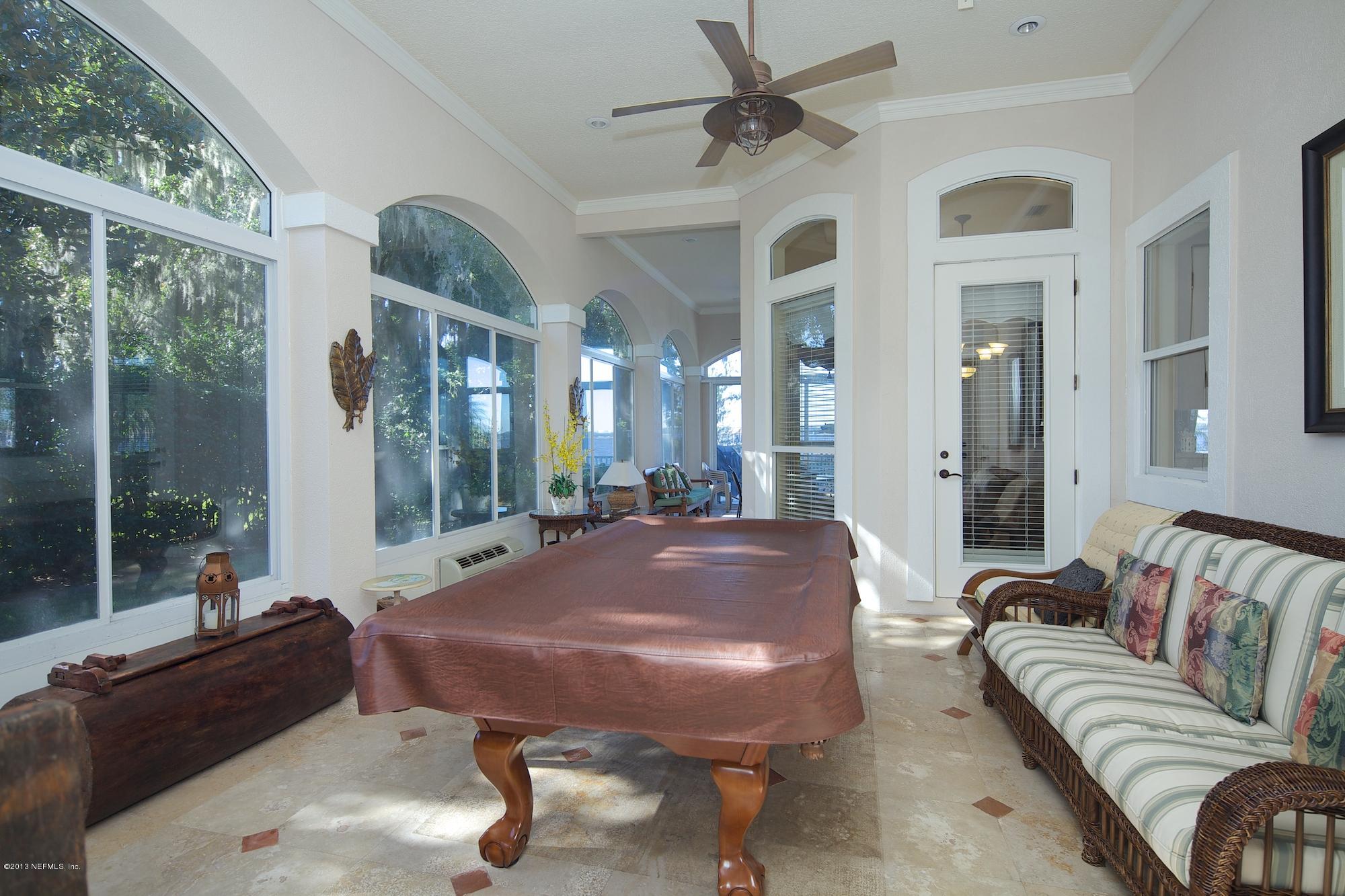 12946 Mandarin Road Jacksonville, FL 32223 - Photo 49 of 67 a living room with furniture a rug and a large window