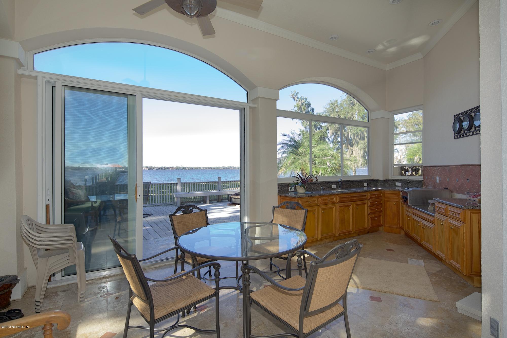 12946 Mandarin Road Jacksonville, FL 32223 - Photo 51 of 67 a kitchen with a table chairs and a kitchen view
