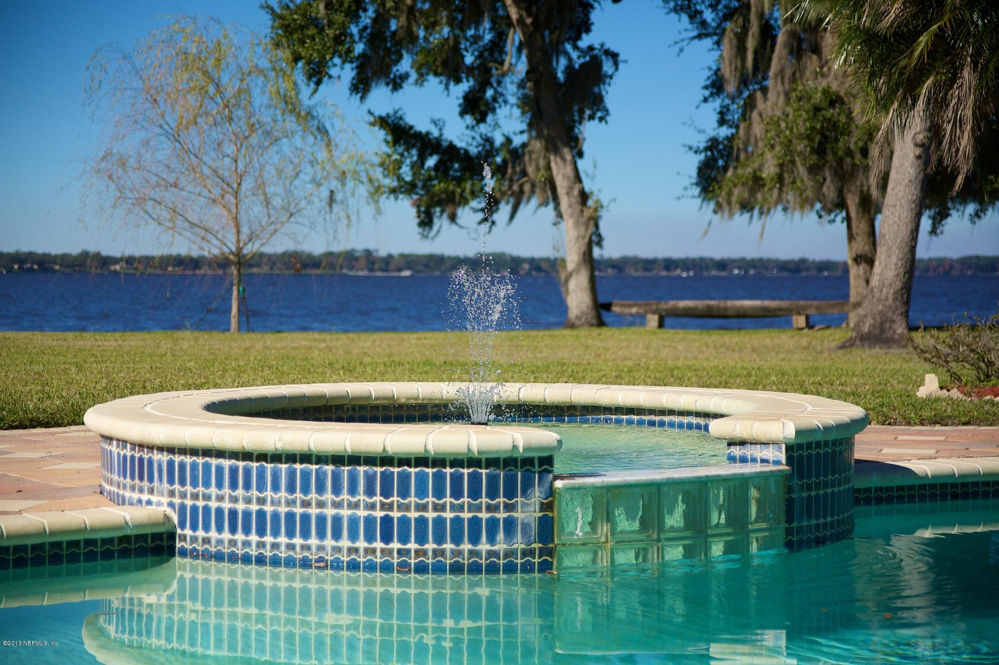 12946 Mandarin Road Jacksonville, FL 32223 - Photo 6 of 67 a view of a swimming pool with a patio and a garden