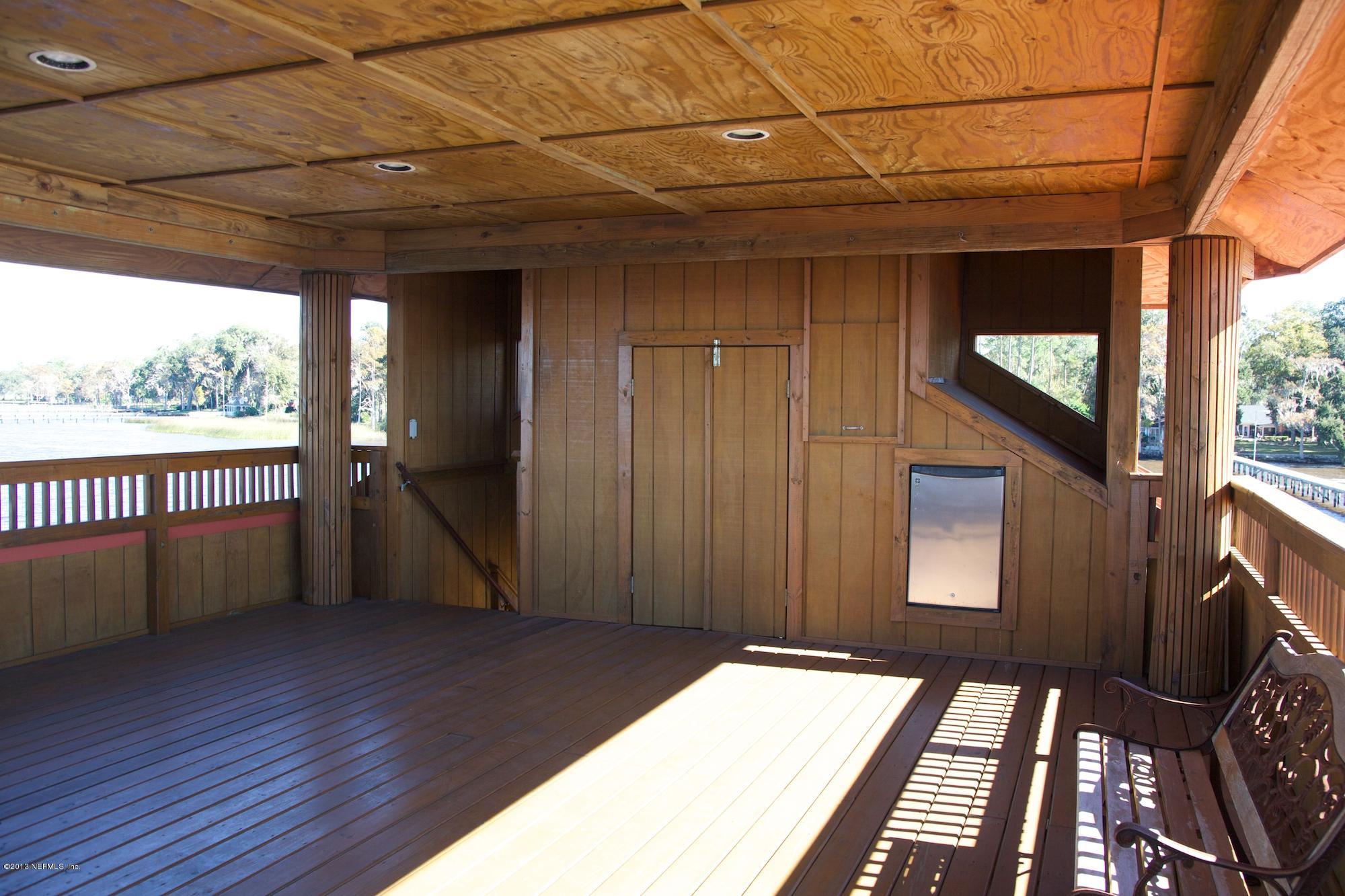 12946 Mandarin Road Jacksonville, FL 32223 - Photo 61 of 67 a view of a balcony with wooden floor and iron stairs