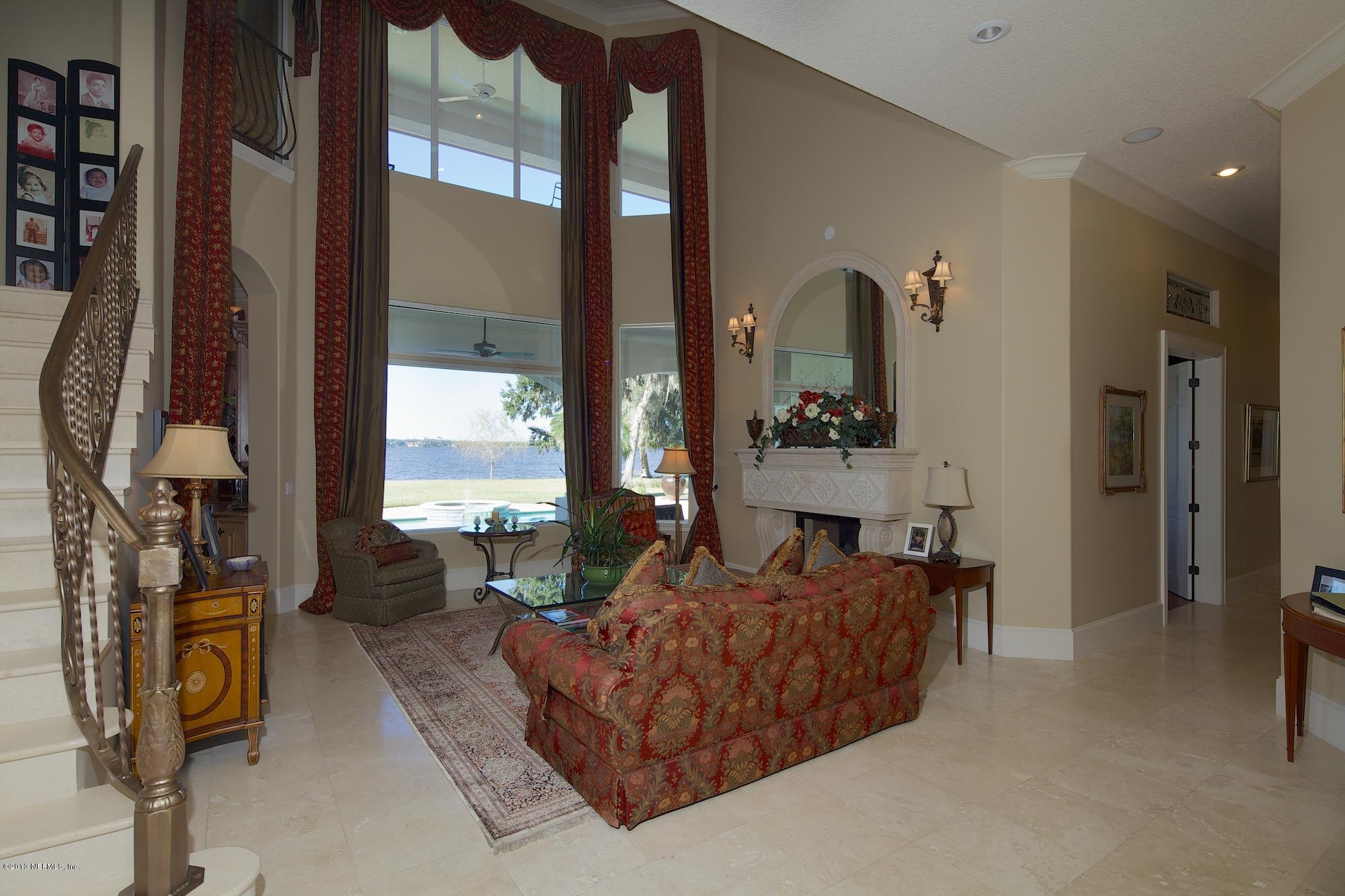 12946 Mandarin Road Jacksonville, FL 32223 - Photo 9 of 67 a living room with furniture and a fireplace