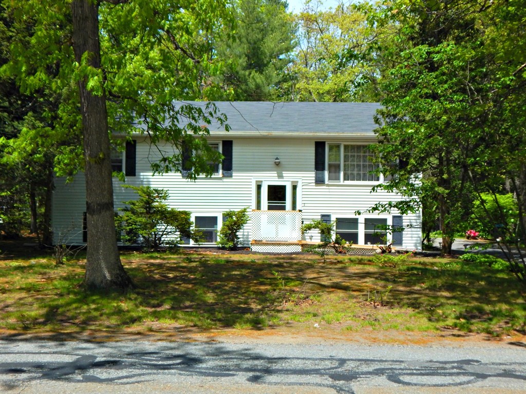 174 Ayer Road Shirley, MA 01464 - Photo 1 of 30 a front view of a house with a garden and trees