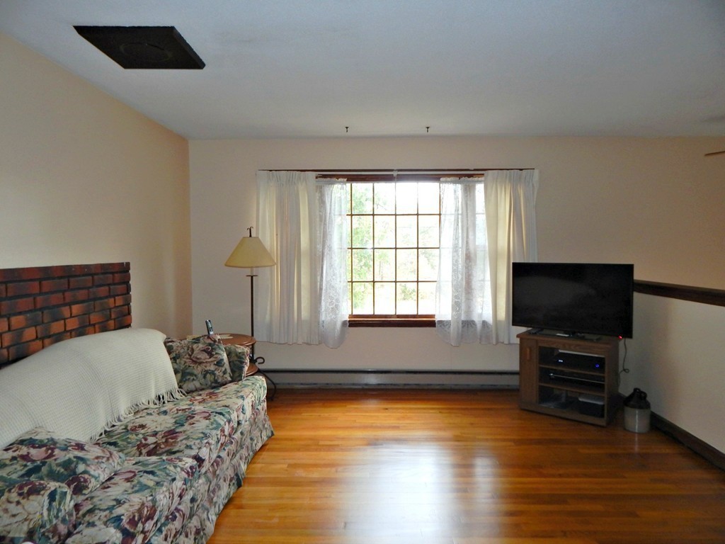 174 Ayer Road Shirley, MA 01464 - Photo 2 of 30 a living room with furniture and a flat screen tv