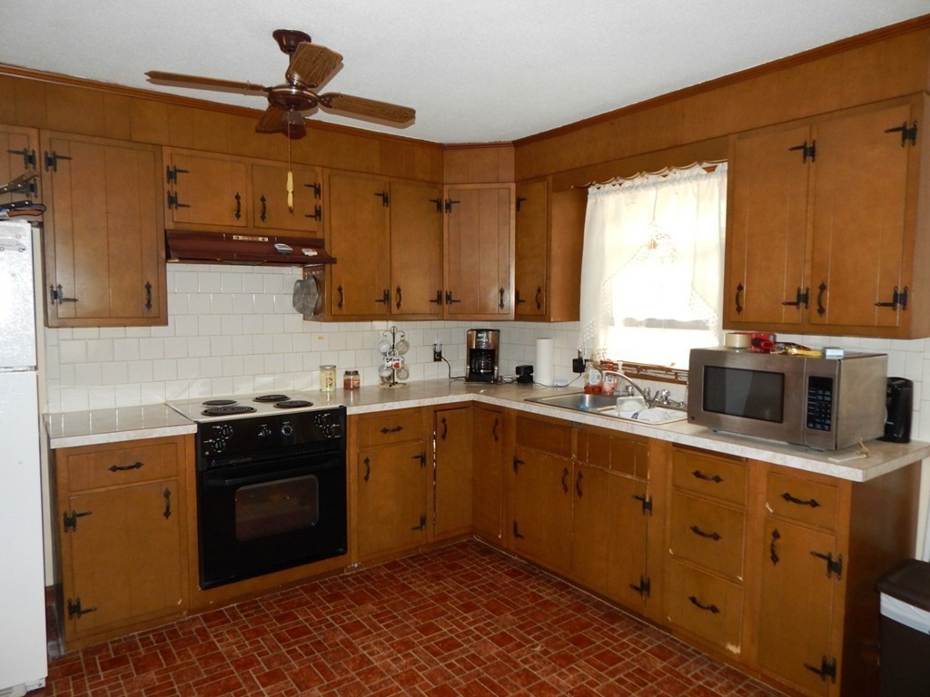 174 Ayer Road Shirley, MA 01464 - Photo 6 of 30 a kitchen with stainless steel appliances granite countertop a sink a stove a refrigerator and cabinets
