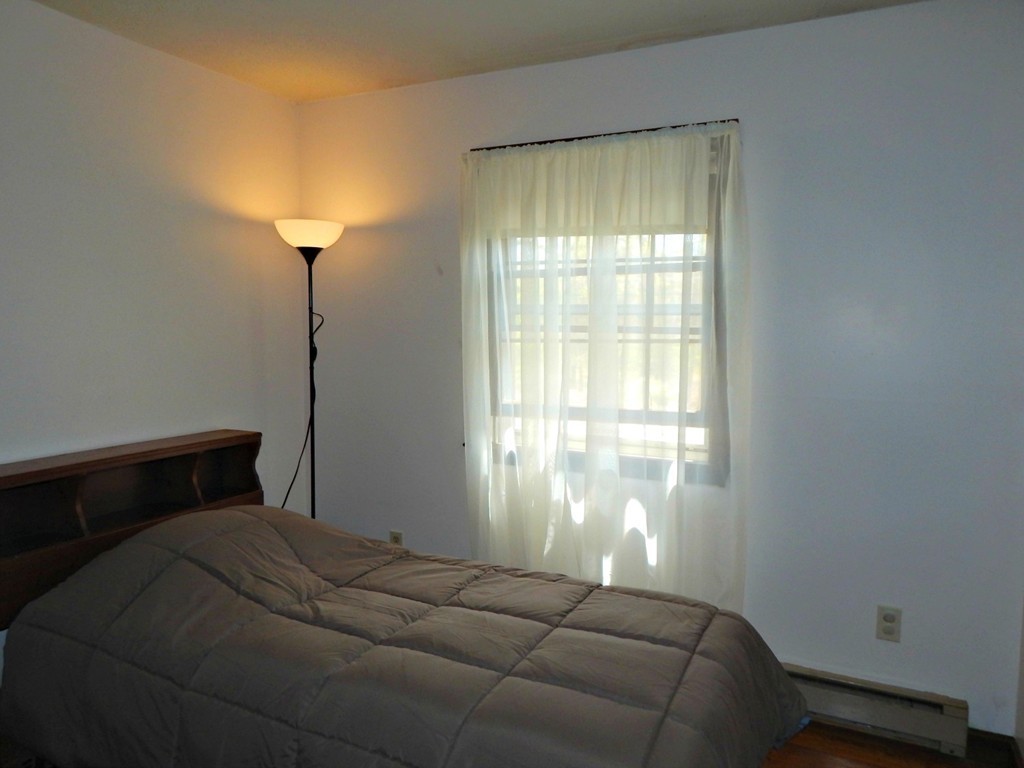 174 Ayer Road Shirley, MA 01464 - Photo 8 of 30 a bedroom with a bed and a window