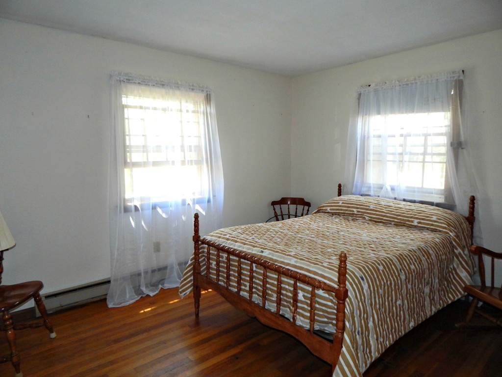 174 Ayer Road Shirley, MA 01464 - Photo 9 of 30 a bed sitting in a bedroom next to a window