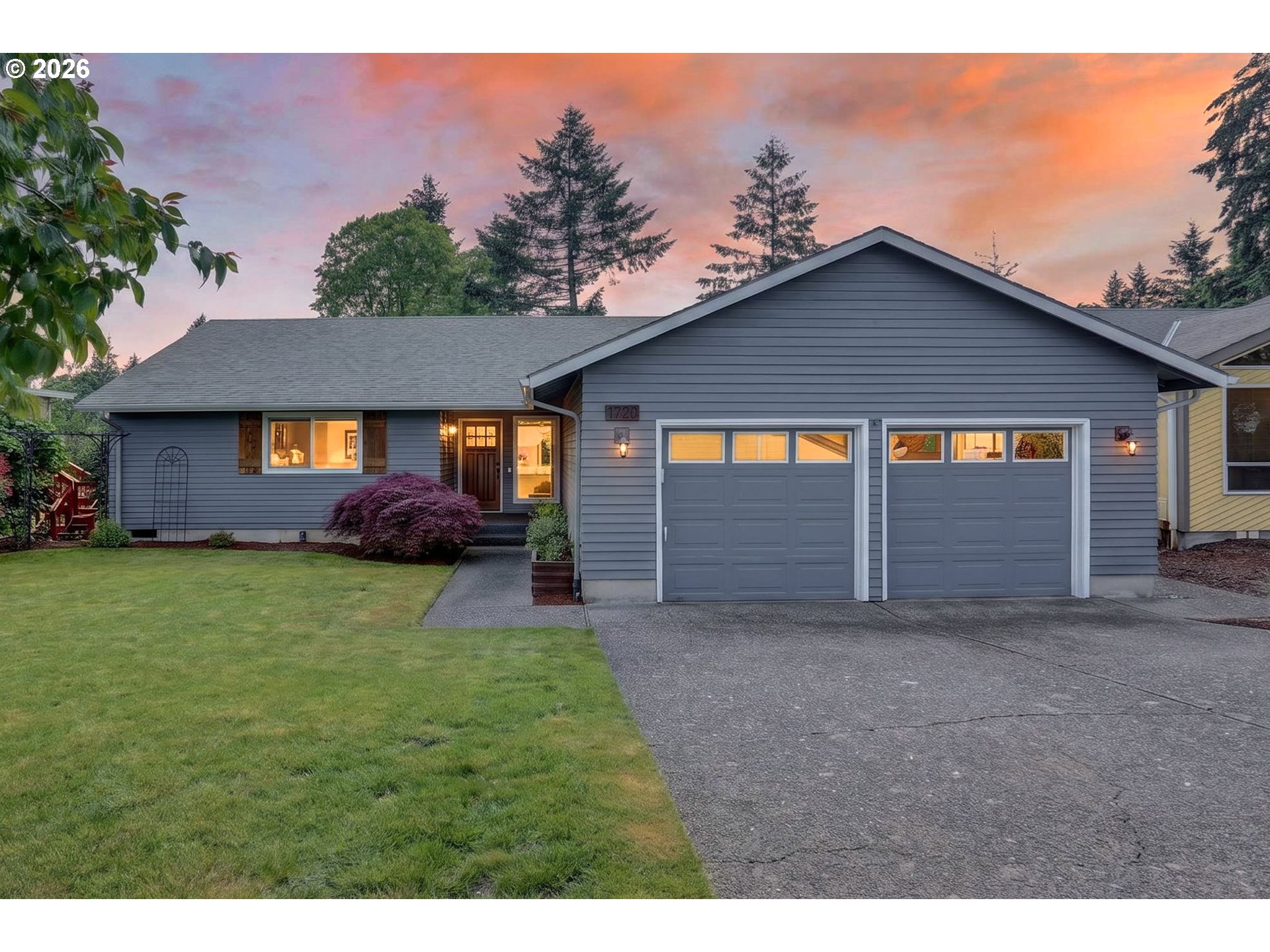 1776 Southeast 114th Place Portland, OR 97216 - Photo 1 of 47 a front view of a house with a yard and garage