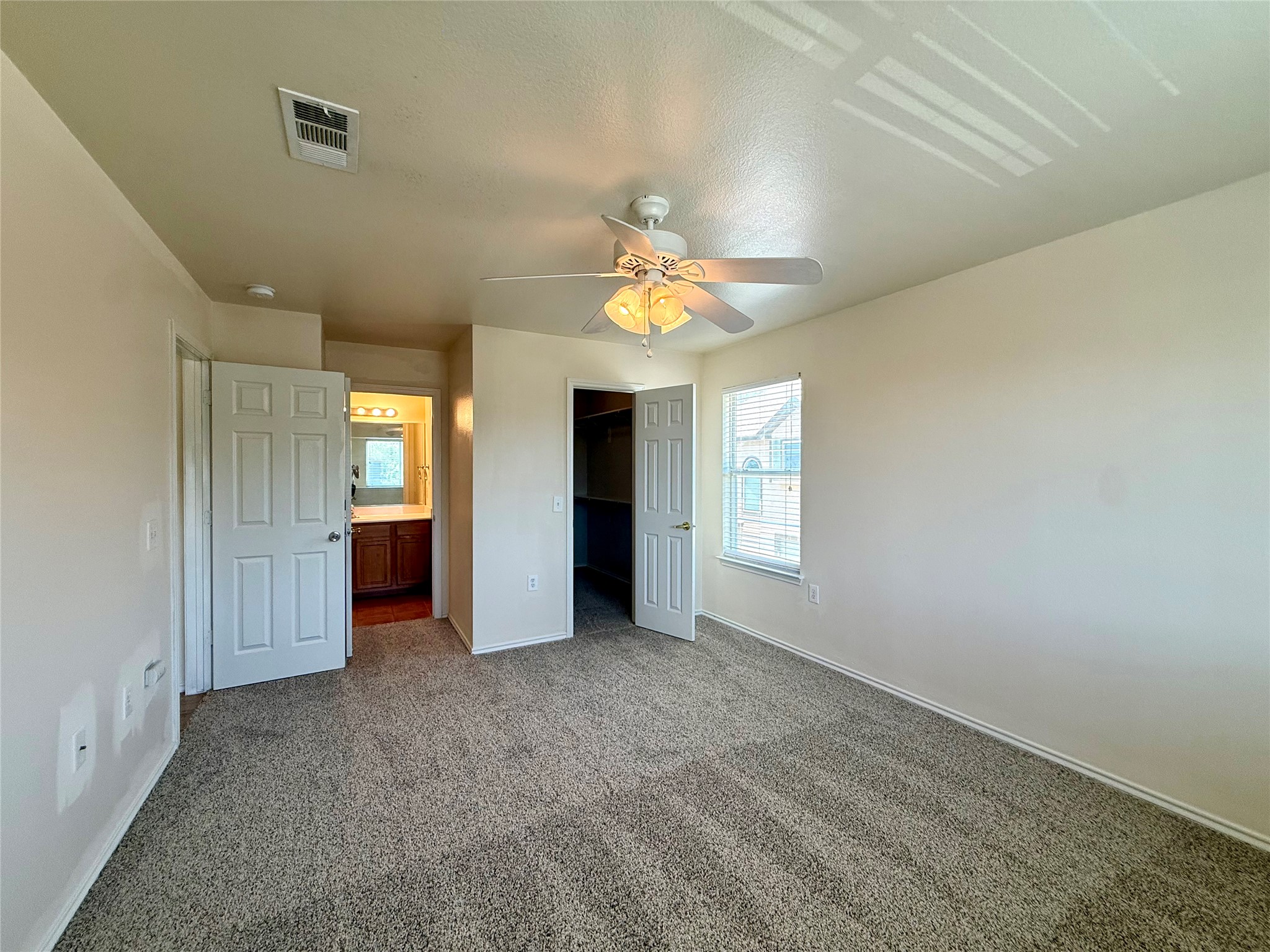 6912 Meador Avenue, Unit A Austin, TX 78752 - Photo 15 of 24 an empty room with windows and a chandelier fan