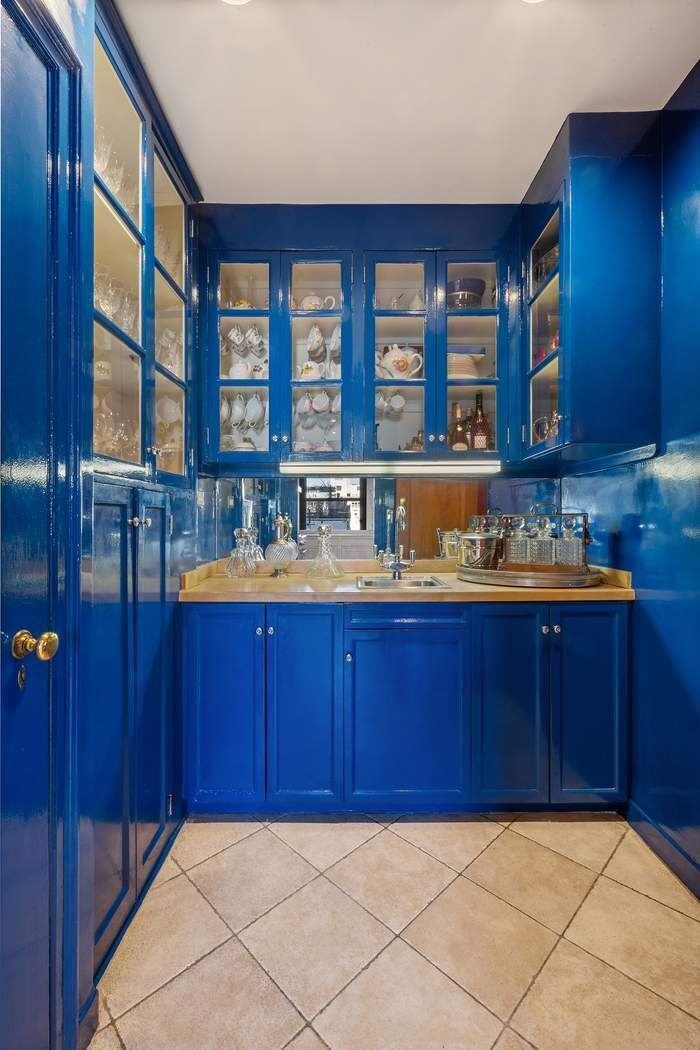 215 East 72nd Street, Unit 9W Manhattan, NY 10021 - Photo 12 of 15 a kitchen with a sink and wooden cabinets