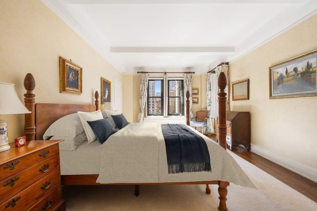 215 East 72nd Street, Unit 9W Manhattan, NY 10021 - Photo 3 of 15 a bedroom with a bed and wooden floor