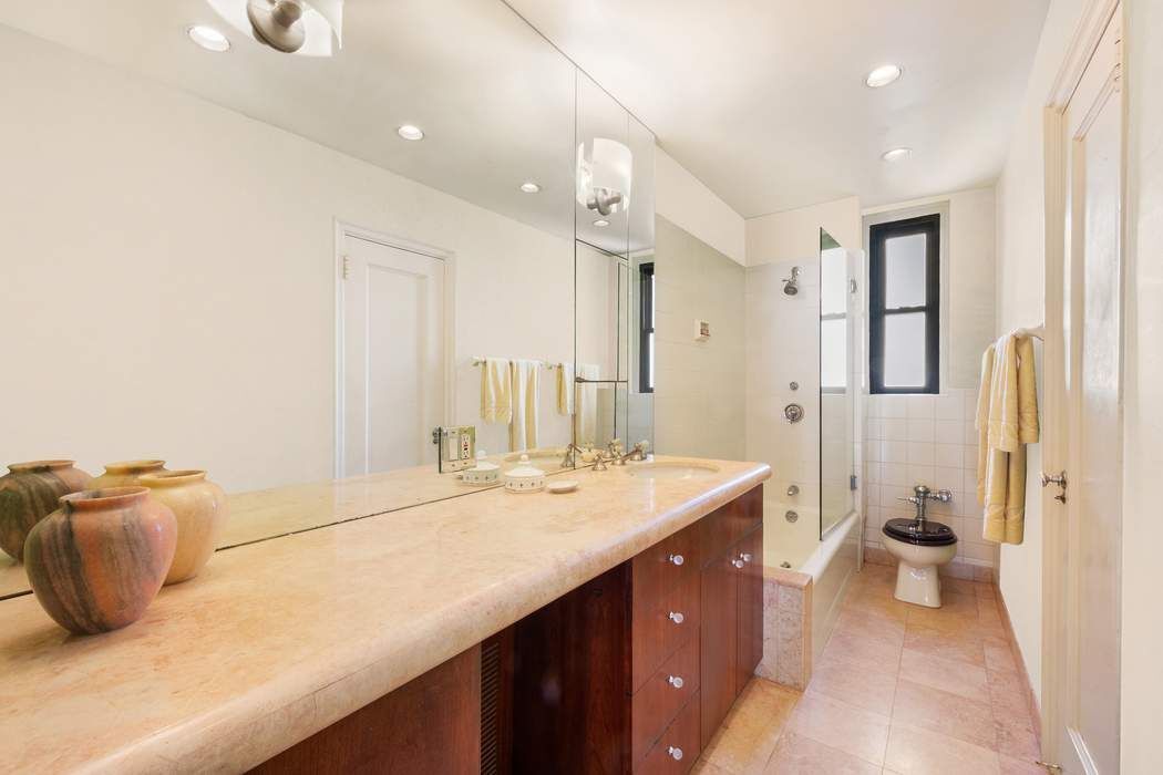 215 East 72nd Street, Unit 9W Manhattan, NY 10021 - Photo 4 of 15 a bathroom with a sink double vanity and a mirror