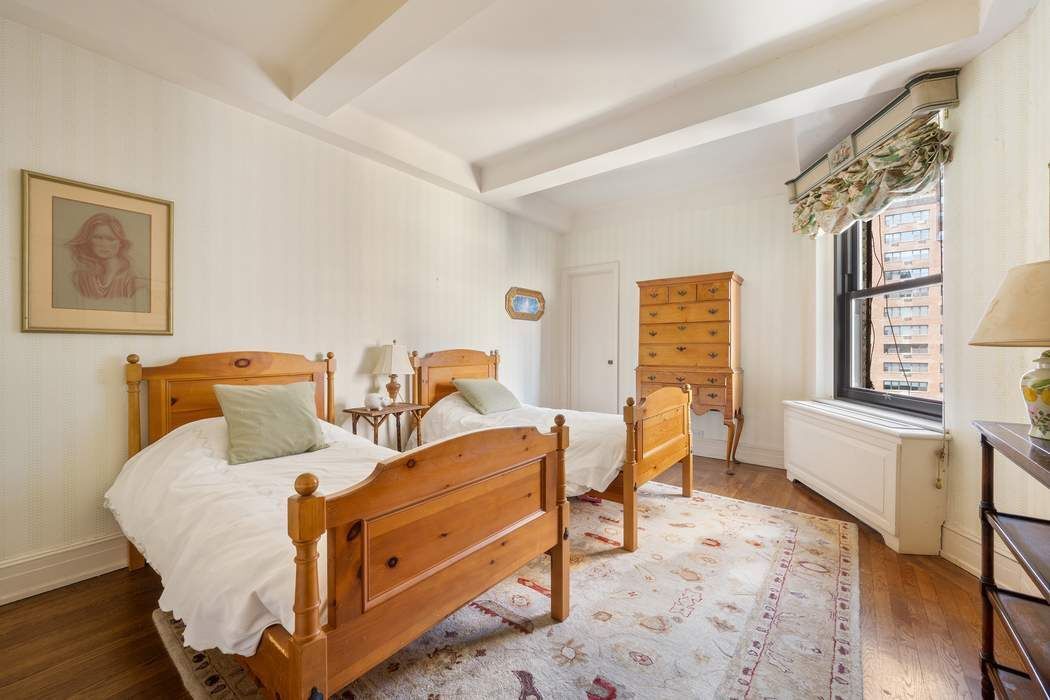 215 East 72nd Street, Unit 9W Manhattan, NY 10021 - Photo 5 of 15 a bed room with a bed and a chair