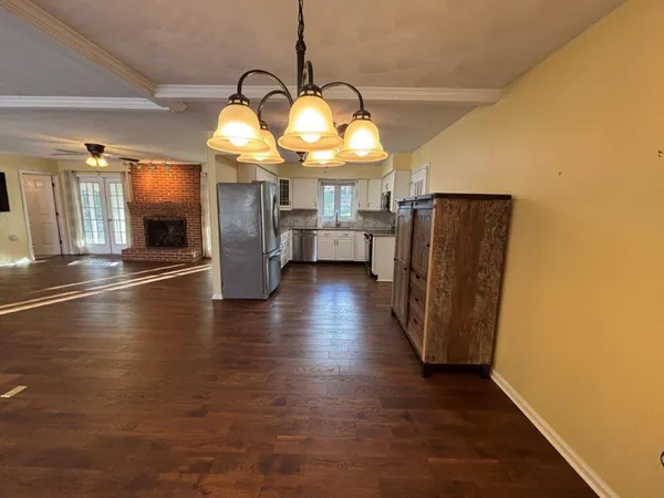 a kitchen with granite countertop white cabinets and a sink