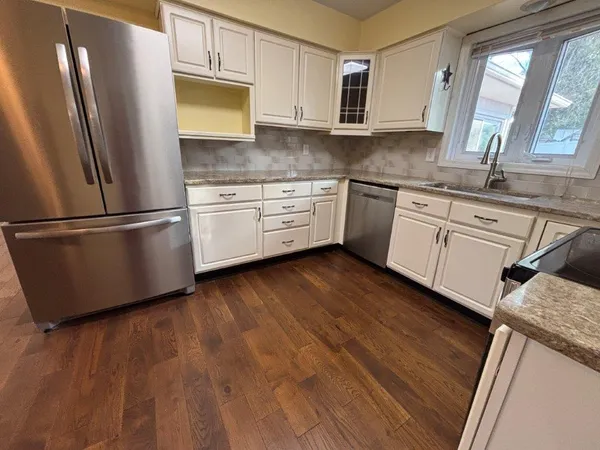 an empty room with wooden floor and closet