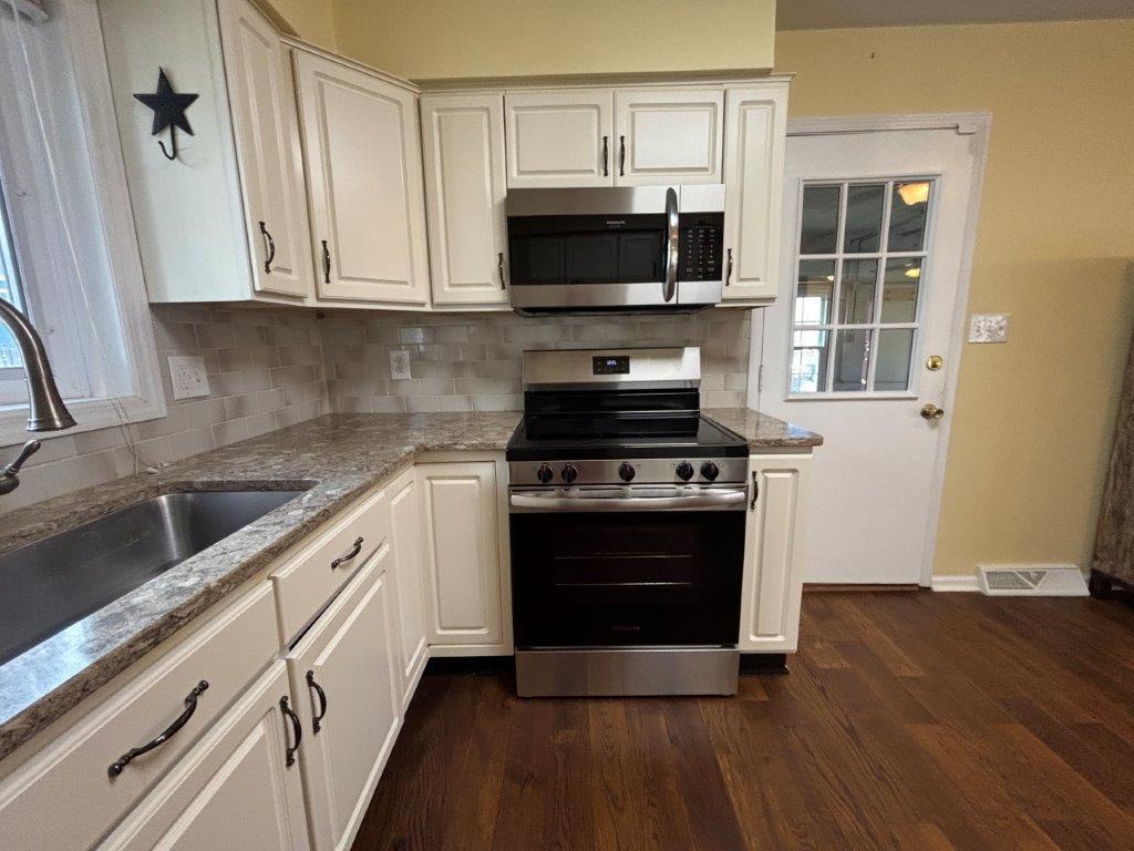 136 Grimes Street Roanoke, VA 24019 - Photo 16 of 101 a kitchen with stainless steel appliances a stove a microwave and sink