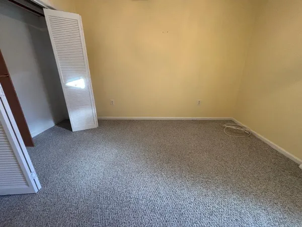 a view of a room with wooden floor and windows