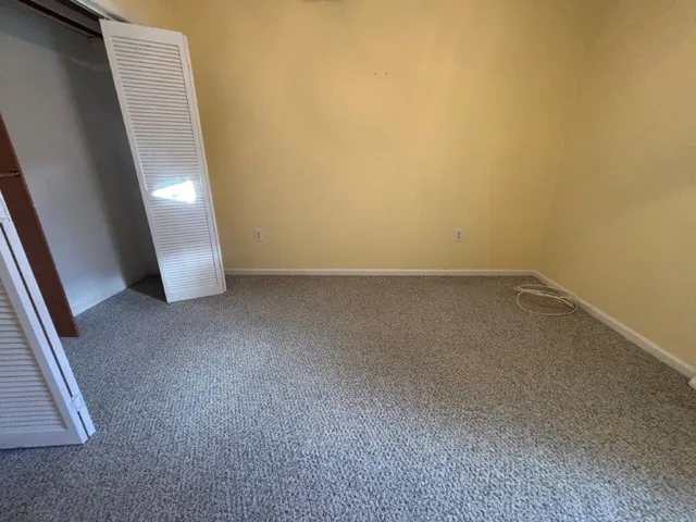 a view of a room with wooden floor and windows