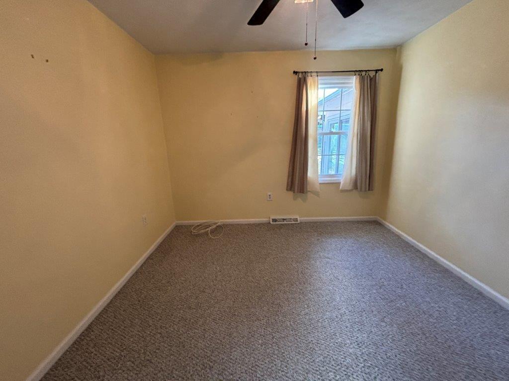 136 Grimes Street Roanoke, VA 24019 - Photo 24 of 101 an empty room with a window and a ceiling fan