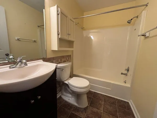a view of an empty room with a fireplace and a window