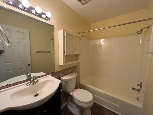 a view of a livingroom with wooden floor and a sink
