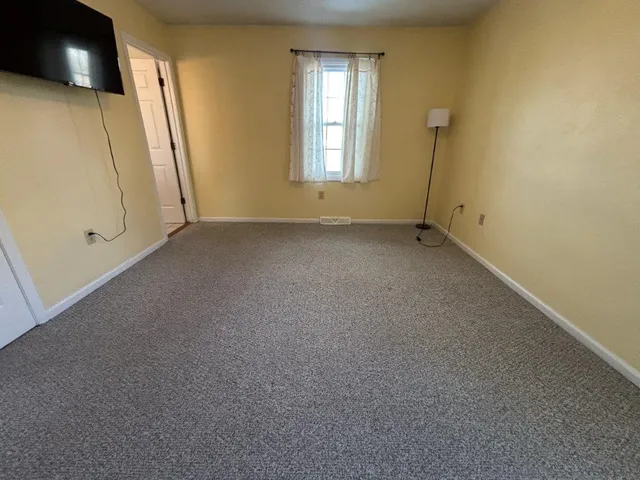 a living room with furniture gym equipment and a fireplace