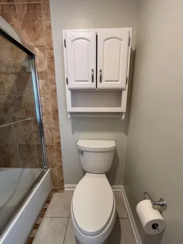 a front view of a house with a yard and potted plants