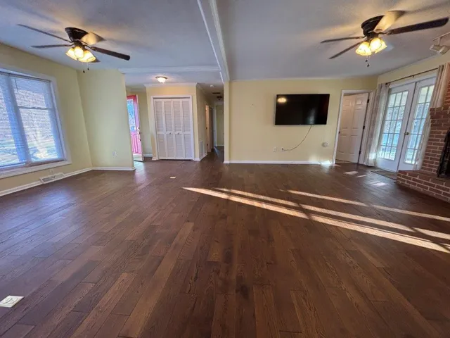 a view of a living room with hardwood floor and a window