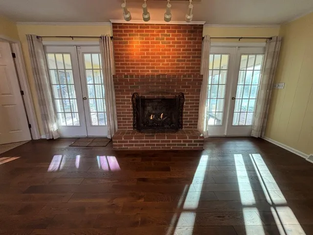 a view of a livingroom with wooden floor and a ceiling fan