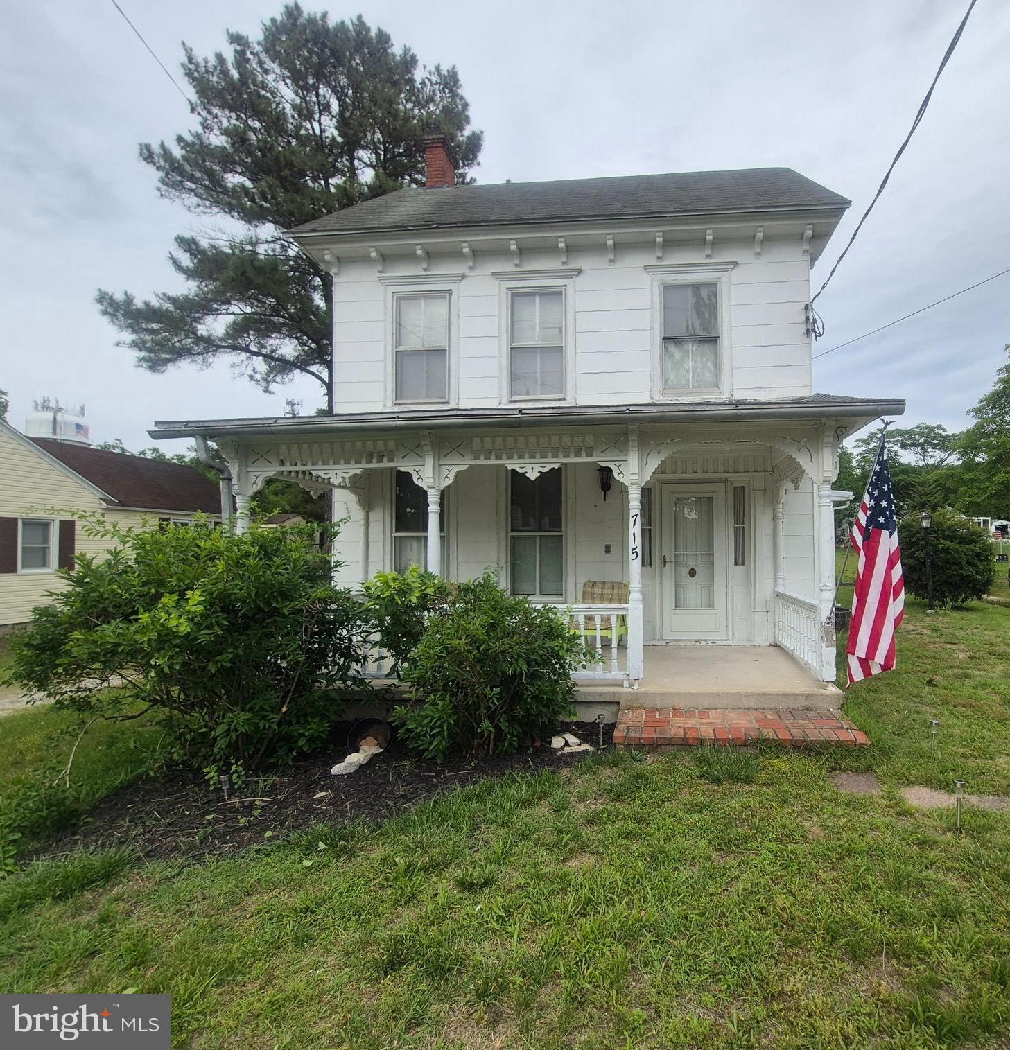 715 Main Street Sharptown, MD 21861 - Photo 1 of 36 a front view of a house with garden