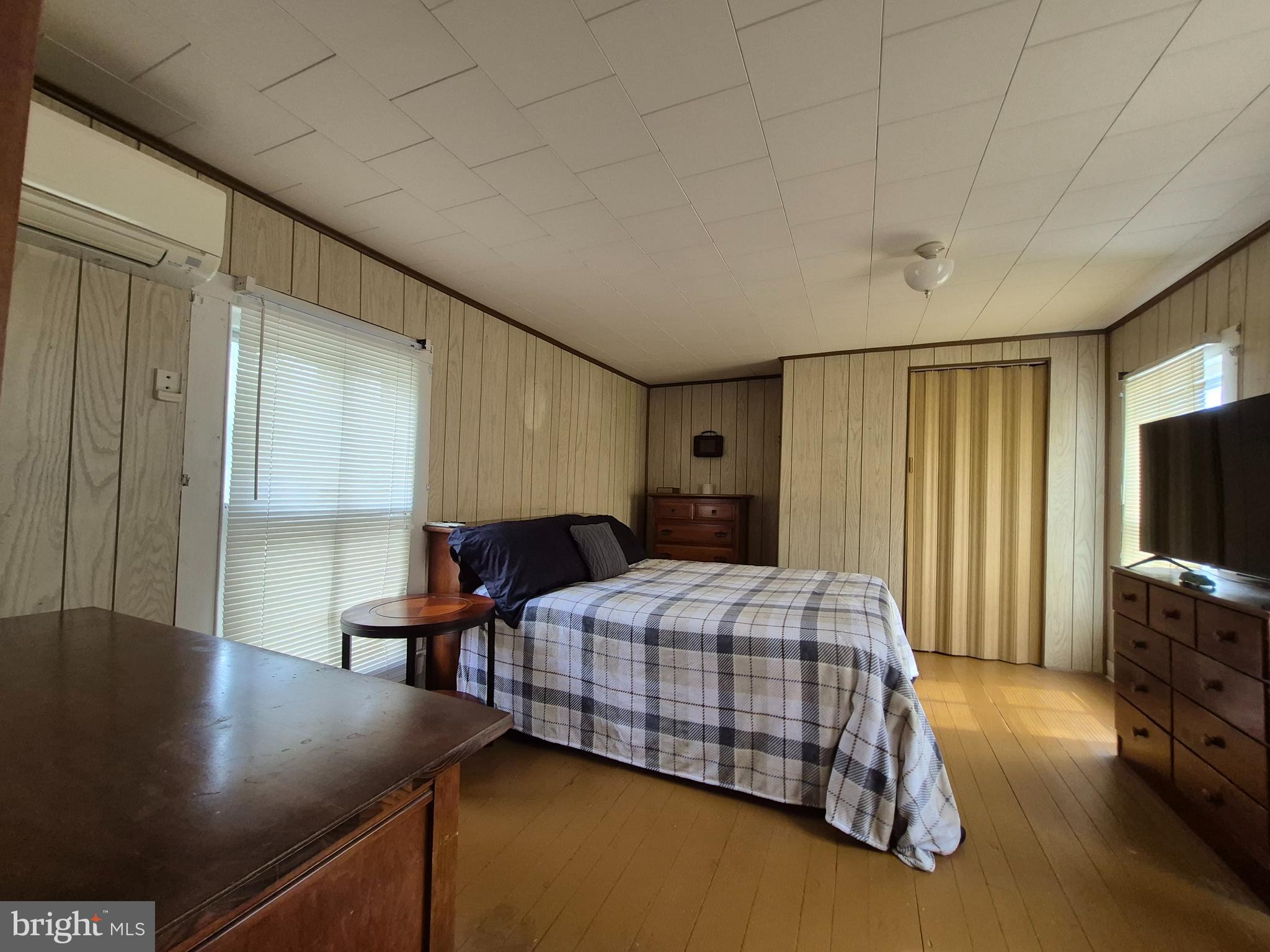 715 Main Street Sharptown, MD 21861 - Photo 20 of 36 a bedroom with a bed window and a flat screen television