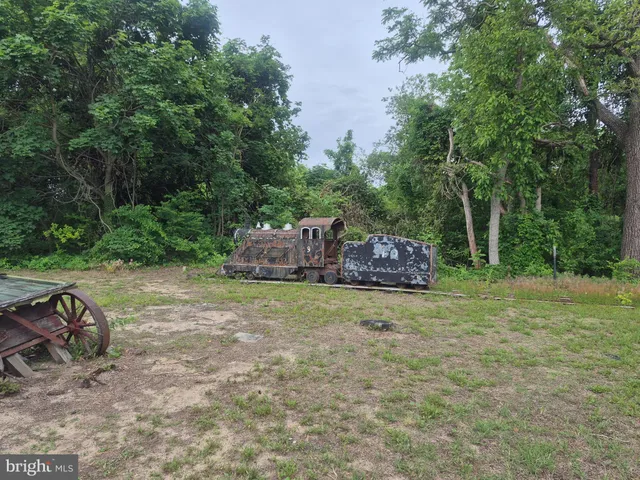 a backyard of a house with a garden and outdoor seating